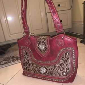 A red crystal studded purse
